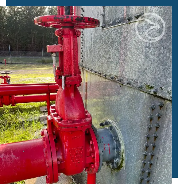 Certified inspector documenting the condition of a fire water storage tank